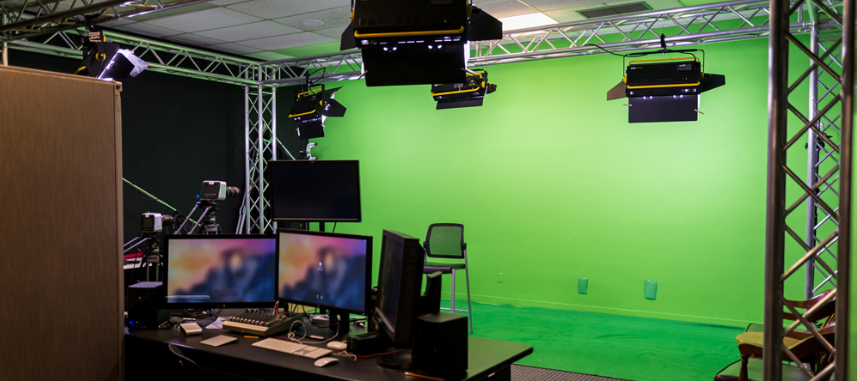 Production Studio with Green Screen, Lights, and Editing Monitors